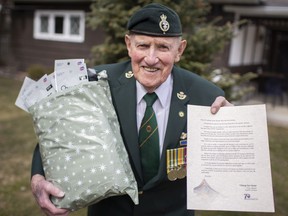 Bernard Cote, 91, a Korean War veteran, holds a bag of face masks and a letter from the prime minister of South Korea at his home in Windsor on Tuesday, March 9, 2021.