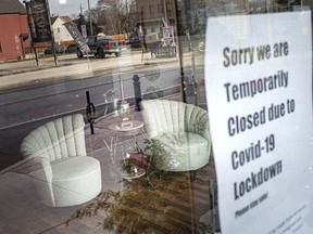 A sign informing customers of closure due to the lockdown is seen on the front door of Timeless Treasures in Walkerville, on the first day of a stay-at-home order from the Provincial government, Thursday, Jan. 14, 2020.