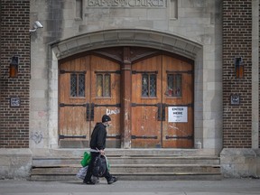 A man carries his belongings outside the Downtown Mission of Windsor location at 664 Ouellette Ave. on March 25, 2021.