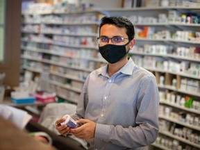 Sajan Patel, manager of Pharmasave Westside Pharmacy at 1550 Huron Church Rd. in Windsor, readies the pharmacy to receive doses of the AstraZeneca COVID-19 vaccine. Photographed March 10, 2021.