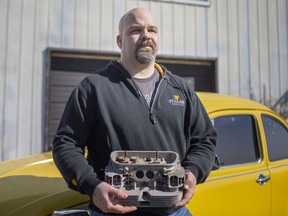 Dale Haggith, a co-ordinator of mechanical engineering technology automotive product design at St. Clair College, holds the engine head of a 1973 Volkswagon Super Beetle that he uses to instruct his students, on Friday, March 12, 2021.