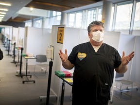 Windsor Regional Hospital CEO, David Musyj, gives a tour of the COVID-19 vaccination centre at the University of Windsor's Windsor Hall, on Friday, March 19, 2021.