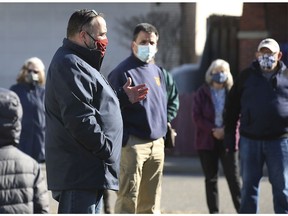 Windsor City councillor Rino Bortolin speaks to neighbourhood residents in an alley near Church Street and Vera Place on Saturday, March 20, 2021. It was part of a "walk and talk" event  regarding the rash of recent house fires.