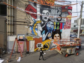 Windsor is offering grants to artists to be creative in the city. Daniel Bombardier a.k.a DENIAL is shown Oct. 29, 2019, working on a large mural for the Windsor International Film Festival in what became WIFF Alley across the street from the Capitol Theatre.