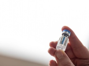 Health Department employee Janet Gerber holds the first vial of the Janssen COVID-19 vaccine at Louisville Metro Health and Wellness headquarters on March 4, 2021 in Louisville, Ky.