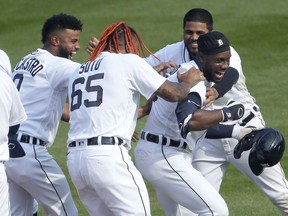 DETROIT, MI -  APRIL 6:  Akil Baddoo #60 of the Detroit Tigers, right, celebrates with Willi Castro #9, Gregory Soto #65 and Jeimer Candelario #46 after hitting a single to drive in Harold Castro and defeat the Minnesota Twins 4-3 in 10 innings at Comerica Park on April 6, 2021, in Detroit, Michigan.