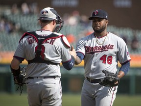 Mitch Garver #8 of the Minnesota Twins and Alex Colome #48 of the Minnesota Twins celebrate their 3-2 win against the Detroit Tigers at Comerica Park on April 07, 2021 in Detroit, Michigan.