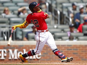 Ronald Acuna Jr. of the Atlanta Braves hits a two run home run in the fifth inning of an MLB game against the Miami Marlins at Truist Park on April 15, 2021 in Atlanta, Georgia. All players are wearing the number 42 in honor of Jackie Robinson Day.