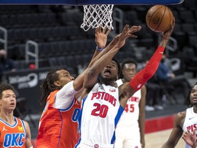Josh Jackson of the Detroit Pistons shoots the ball against Moses Brown of the Oklahoma City Thunder during the third quarter of the NBA game at Little Caesars Arena on April 16, 2021 in Detroit, Michigan.
