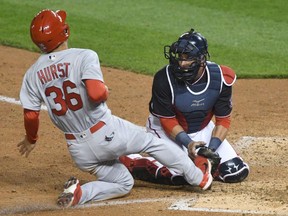 Yan Gomes of the Washington Nationals tags out Scott Hurst of the St. Louis Cardinals as he attempts to run home on a hit by John Nogowski in the eighth inning at Nationals Park on April 19, 2021 in Washington, DC.