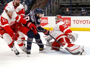 Goaltender Thomas Greiss of the Detroit Red Wings stops a shot by Oliver Bjorkstrand of the Columbus Blue Jackets during the second period at Nationwide Arena on April 27, 2021 in Columbus, Ohio.