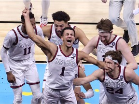 Jalen Suggs of the Gonzaga Bulldogs celebrates with teammates after making a game-winning three point basket in overtime to defeat the UCLA Bruins 93-90 during the 2021 NCAA Final Four semifinal at Lucas Oil Stadium on April 03, 2021 in Indianapolis, Indiana.