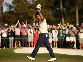 Hideki Matsuyama of Japan celebrates on the 18th green after winning the Masters at Augusta National Golf Club on April 11, 2021 in Augusta, Georgia.