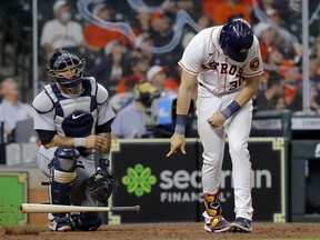 Kyle Tucker of the Houston Astros slams his bat as he strikes out against the Detroit Tigers at Minute Maid Park on April 14, 2021 in Houston, Texas.