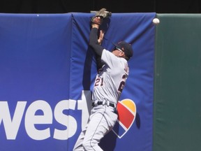 JaCoby Jones of the Detroit Tigers leaps and just misses this ball that hits off the wall for a triple off the bat of Matt Chapman of the Oakland Athletics in the first inning at RingCentral Coliseum on April 17, 2021 in Oakland, California.