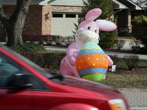 A masked Easter bunny and colourful egg, shown April 1, 2021, greets motorists and passersby along Riverside Drive East. Health authorities are urging socially distanced outdoor gatherings and face masks over the Easter long weekend.