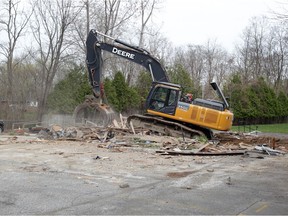 A Jones Group Demolition excavator clears debris after demolishing the old Girl Guides of Canada building on Malden Road in LaSalle Saturday April 10, 2021.