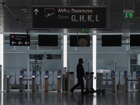 A passenger walks in a terminal of the Franz-Josef-Strauss airport in Munich, southern Germany, on April 8, 2021, amid the ongoing COVID-19 pandemic.