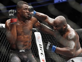 Derrick Lewis punches Francis Ngannou during a heavyweight bout at UFC 226, Saturday, July 7, 2018, in Las Vegas.
