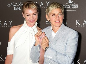 Portia DeRossi and Ellen DeGeneres show off their wedding rings as they arrive at the Neil Lane Bridal Collection Debut at Drai's at The W Hollywood Rooftop Los Angeles.