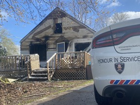 A Windsor police vehicle sits at the scene of a house fire in the 1800 block of Balfour Boulevard in Windsor on April 21, 2021.