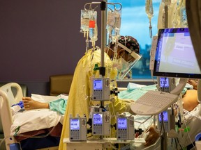 A respiratory therapist checks a coronavirus disease (COVID-19) patient inside the intensive care unit of Humber River Hospital in Toronto April 15, 2021.