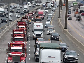 A convoy of dump trucks moves east in the express lanes of the 401 as part of a protest on Thursday, April 15 2021