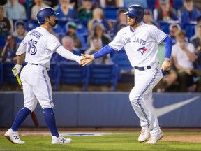 Toronto Blue Jays catcher Danny Jansen (right) celebrates with centre fielder Randal Grichuk after scoring against the Los Angeles Angels during the second inning at TD Ballpark on April 10, 2021.