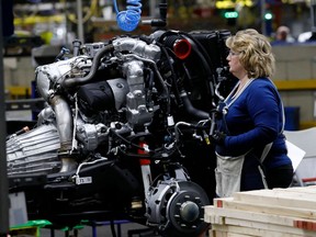 (FILES) In this file photo line workers work on the chassis of fill-size General Motors pickup trucks at the Flint Assembly plant on June 12, 2019 in Flint, Michigan. - General Motors reported higher first-quarter US auto sales on April 1, 2021 amid rising consumer confidence, but car inventories fell sharply due to the global semiconductor shortage. The largest US automaker pointed to continued strong demand for larger vehicles such as full-size sport utility vehicles and pickup trucks.