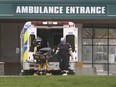 A paramedic loads a stretcher into an ambulance on Friday, April 16, 2021, at the Windsor Regional Hospital Met campus. Toronto area COVID-19 hospital patients have begun being transferred to Windsor.