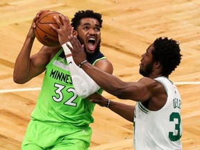 Minnesota Timberwolves center Karl-Anthony Towns drives to the basket defended by Boston Celtics forward Semi Ojeleye during the first half at TD Garden.
