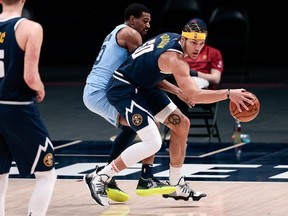 Denver Nuggets forward Aaron Gordon controls the ball as Memphis Grizzlies guard De'Anthony Melton guards in the second quarter at Ball Arena.