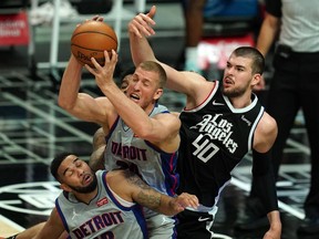Detroit Pistons center Mason Plumlee and guard Cory Joseph battle for the ball with LA Clippers center Ivica Zubac in the second half at Staples Center. The Clippers defeated the Pistons 131-124.