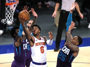 Elfrid Payton of the New York Knicks goes to the basket as Jalen McDaniels and P.J. Washington of the Charlotte Hornets defend during the second half at Madison Square Garden.