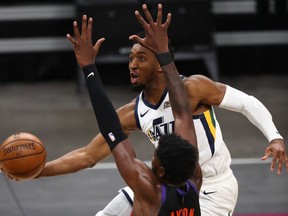 Utah Jazz guard Donovan Mitchell drives to the basket against Phoenix Suns center Deandre Ayton during overtime at Phoenix Suns Arena.