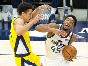 Utah Jazz guard Donovan Mitchell dribbles the ball against Indiana Pacers guard Malcolm Brogdon during the first quarter at Vivint Smart Home Arena.