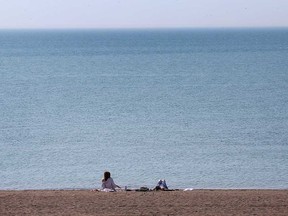 People take advantage of warm weather on April 6, 2021, to enjoy Colchester Beach in the Town of Essex.