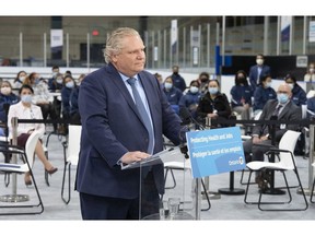 Premier Doug Ford listens to a question in late March as he announced only partial measures to deal with the surge of infection. This week, he finally issued a fuller stay-at-home order.