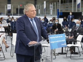 Ontario Premier Doug Ford listens to a question during the daily briefing at a mass vaccination centre in Toronto on Tuesday, March 30, 2021. On Thursday, Ford announced an four-week Ontario-wide "shutdown" that would begin Saturday, in response to an "alarming" surge in COVID-19 infections.





THE CANADIAN PRESS/Frank Gunn ORG XMIT: POS2104011303023424