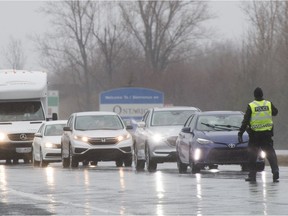 Quebec police stop motorists at a checkpoint near the Ontario border in Rivière Beaudette, west of Montreal, in March 2020.