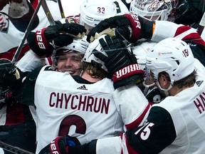 Arizona Coyotes defenseman Jakob Chychrun is mobbed by teammates after scoring the winning goal in overtime to beat the Anaheim Ducks 3-2 at Honda Center. It was Chychrun's third goal of the game.
