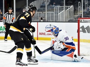 Boston Bruins left wing Taylor Hall tips the puck past New York Islanders goaltender Ilya Sorokin for a goal during the second period at TD Garden.