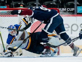 Colorado Avalanche center Nazem Kadri collides with St. Louis Blues goaltender Ville Husso in the third period at Ball Arena.