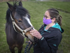 Paige Shepley, program director at the Windsor Essex Therapeutic Riding Association, takes a Lilly out for a walk on Monday, April 12, 2021.