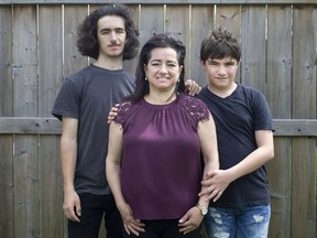 Veronica Cardoso, pictured with her two children, Mateo, 15, and Mauricio, 13, are pictured outside their home on Wednesday, April 28, 2021. Cardoso's husband, and father to Mateo and Maurizo, was killed on the job on January 21, 2009.