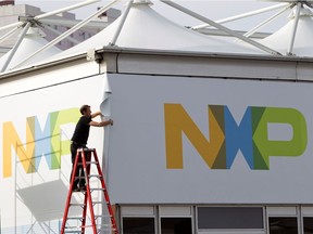 FILE PHOTO: A man works on a tent for NXP Semiconductors in preparation for the 2015 International Consumer Electronics Show (CES) at Las Vegas Convention Center in Las Vegas, Nevada, U.S. on January 4, 2015.