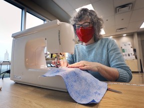 Patricia Savage, a member of the Windsor Essex Sewing Force, works on a mask on Tuesday, April 20, 2021 at the WFCU Centre in Windsor.