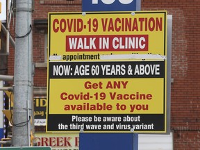 A Covid-19 vaccination sign at the Neighbourhood Drug Store on Wyandotte Street East in Windsor is shown in April 2021.