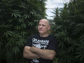 Pot activist and medical marijuana licence holder Leo Lucier is seen Wednesday, Sept. 19, 2018, in the backyard of a friend's home in Amherstburg, Ont., where he's been growing giant marijuana plants.
