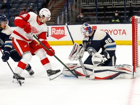 Matiss Kivlenieks stops a shot from Mathias Brome of the Detroit Red Wings during the third period at Nationwide Arena on May 7, 2021 in Columbus, Ohio. Detroit defeated Columbus 5-2.